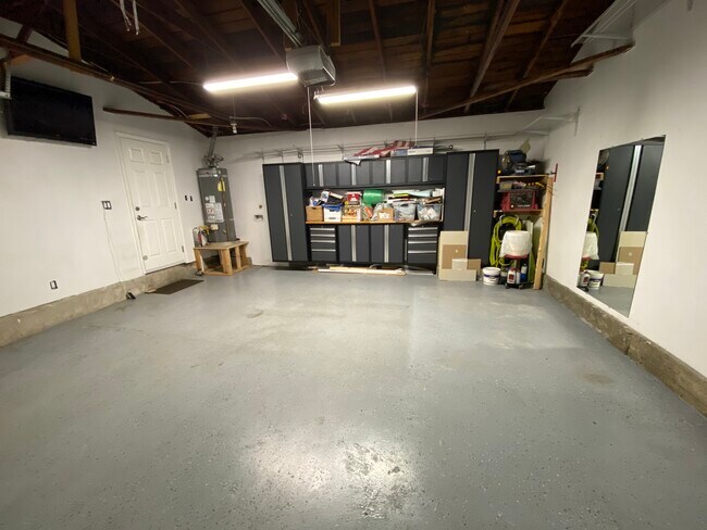 Garage with storage. All items on shelves and side of cabinets have been removed - 8561 Cedar Dr