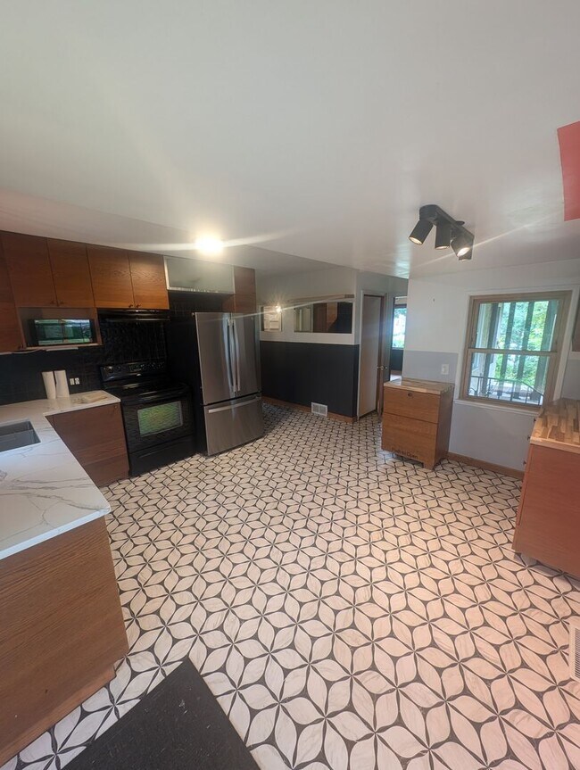 Building Photo - Charming Garden Oasis in West St. Paul – Fire Pit, Pond & Prime Location!