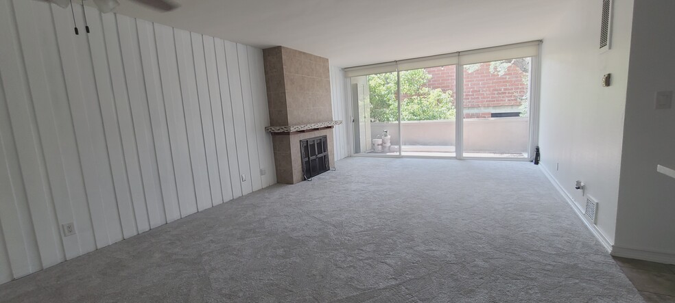 Living Room with fireplace and large sliding patio door - 6375 Green Valley Cir