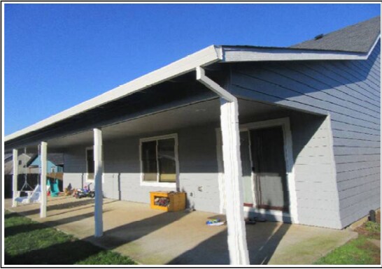 Large covered back patio with porch swing - 1464 Ryan Dr