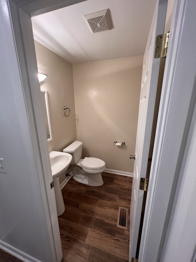 Half bathroom off of the kitchen. - 1298 Cedarcliff Dr