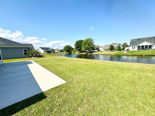 Building Photo - Like New 3 Bedroom & 2 Bath pond front home in Hillsborough! Enjoy the Community Pool, Playground...