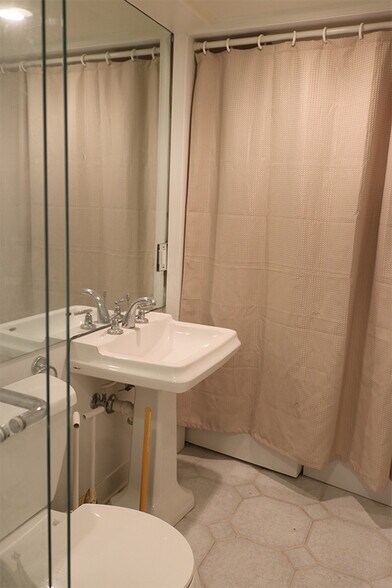 Bathroom curtain conceals washer dryer - 3118 1/2 Dumbarton St NW