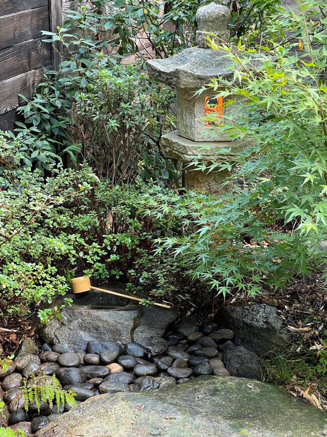 Tea garden includes stone carved water bowl for greeting guests. - 73 Swannanoa Ave