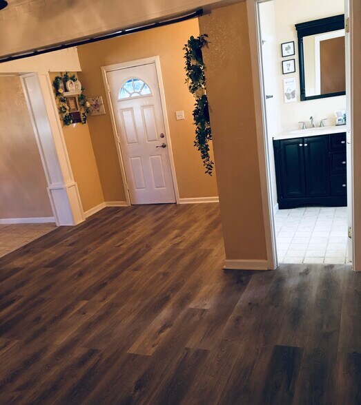 Living room 1 view into 1/2 bath on the right and kitchen on the left - 304 SE 2nd St