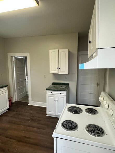 From kitchen, there is access to a full bathroom with shower and basement door - 106 S Raleigh St