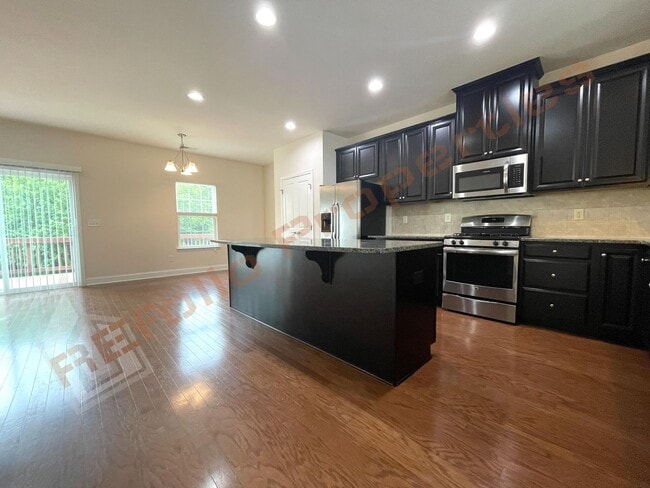 Building Photo - Beautiful 3 Story 3 Bedroom Townhouse with Huge 1st Floor Flex Space with Access to Patio + 2 Car...