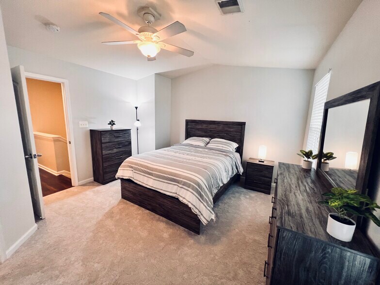 Primary bedroom with walk-in closet and full bathroom. Furnished. - 4148 Strawbridge Ct