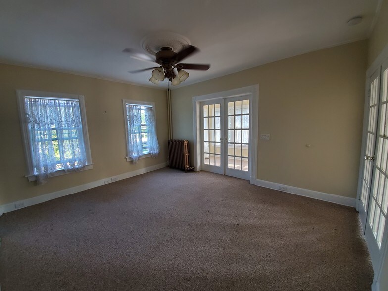 Living room w/2 french doors + ceiling fan - 78 S Carll Ave