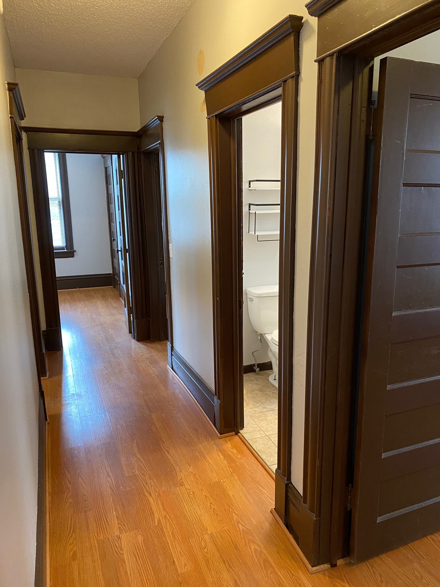 Hallway with three bedroom doors and bathroom in middle - 3228 3rd Ave S