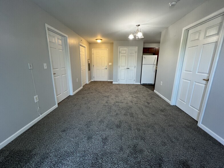 Living Room With Dining Area - Meyer Pointe Senior Apartments