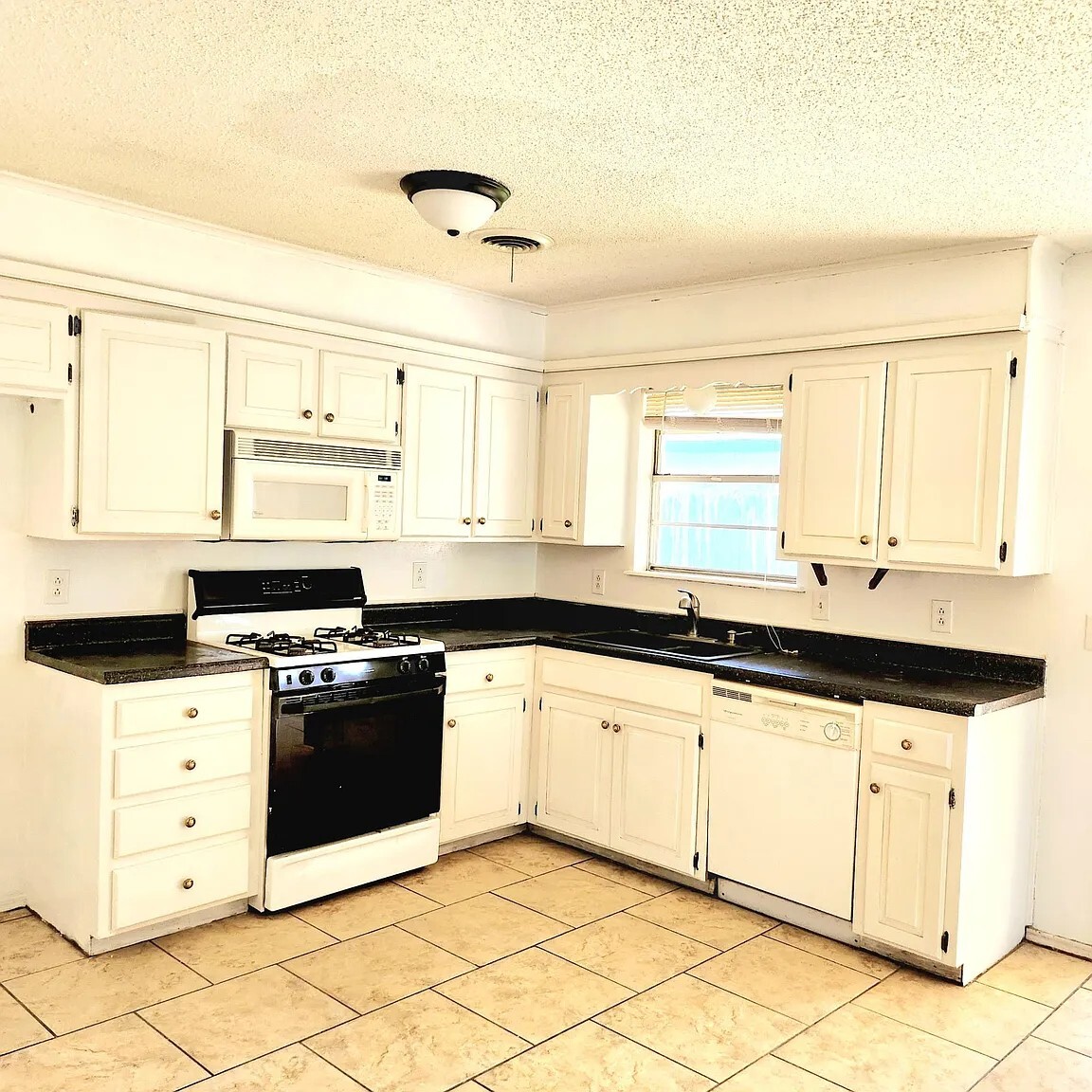 This spacious, open-concept kitchen seamlessly connects to the main living area. - 1301 La Paloma St