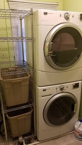 Stackable washer and dryer with shelving in utility room - 425 Virginia Ave
