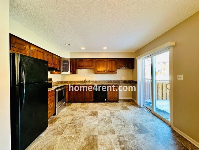 Building Photo - Beautiful Overland Park Townhome w/ Wood Floors, Large Open Kitchen and a Community Pool!