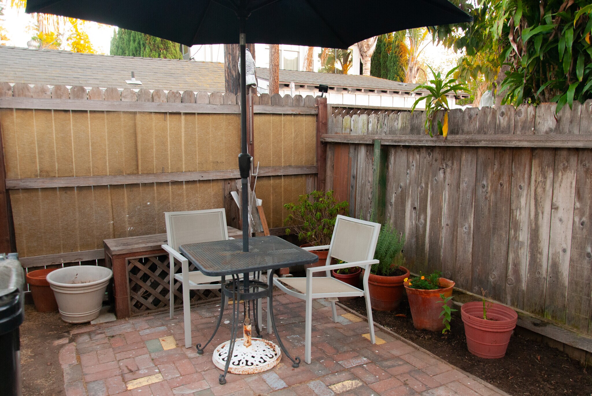 Shared garden space, when entering from the back gate and parking spot. - 936 Palms Blvd