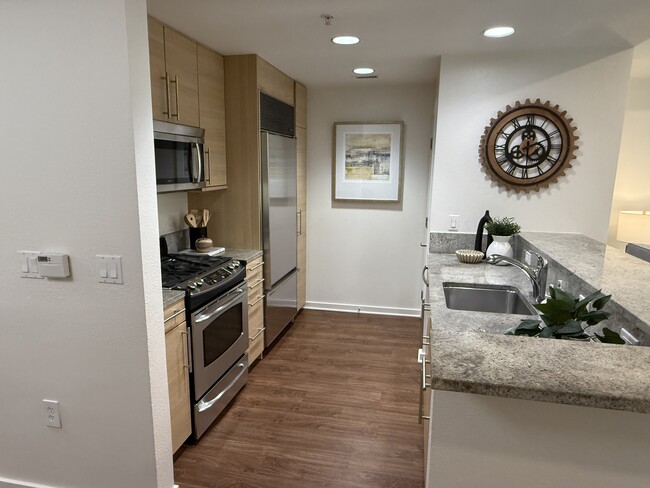 A fully equipped kitchen featuring premium appliances, including a state-of-the-art Sub-Zero refrige - 1655 N California Blvd