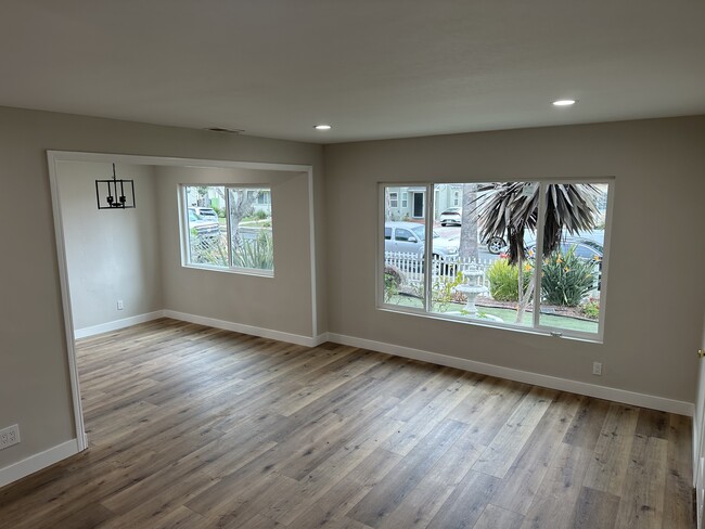 Open concept living and dining with recessed lighting, luxury flooring, with new dual pane windows - 4230 W 169th St