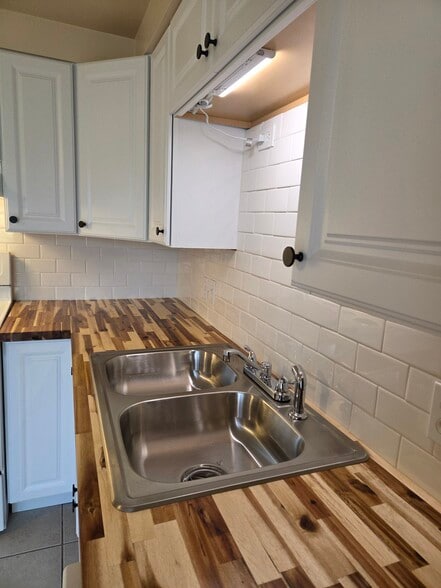 New butcherblock countertops and white subway tile - 496 Mercer Rd