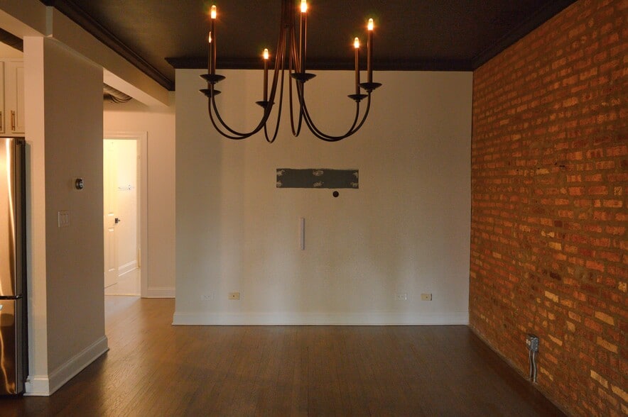 Living room / exposed brick - 1647 W Pratt Blvd
