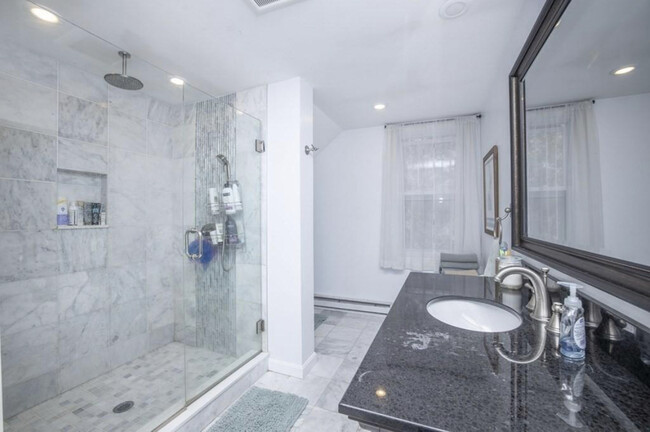 Recently renovated walk in shower with laundry units - 647 N Main St