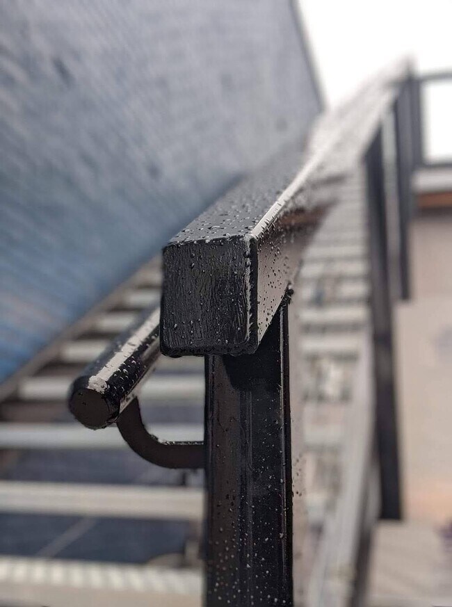 The custom made stairs leading up to the apartments. - 130 E State St