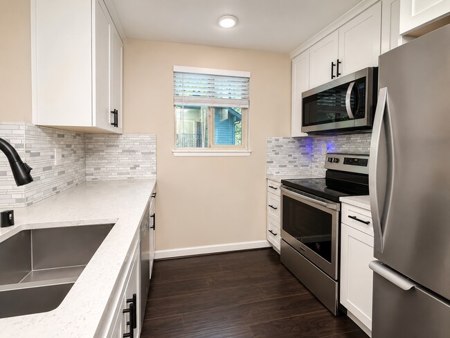 Building Photo - Modern Wooded Condo with Upgraded Kitchen & Private Deck