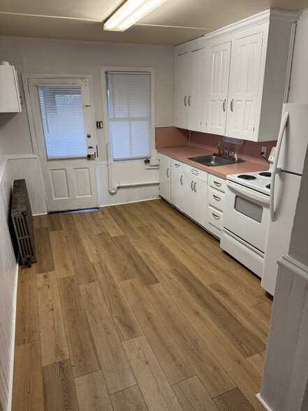 Kitchen looking in from rear room. Rear entry door at end of kitchen. - 321 Lincoln Way W