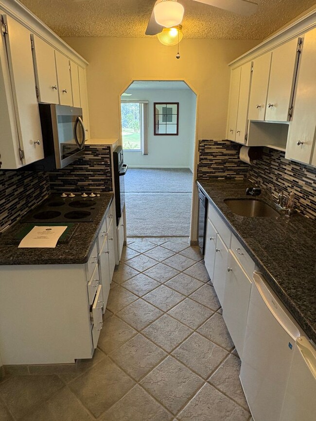 Building Photo - (55+) 2/2 Condo in the Peaceful Miles Grant Golf Course Community