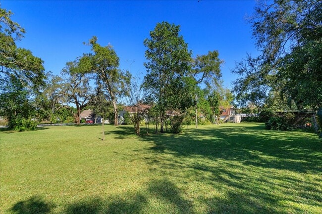 Building Photo - Run don't walk for this one of a kind beautifully maintained Old Florida Charmer on a park like d...