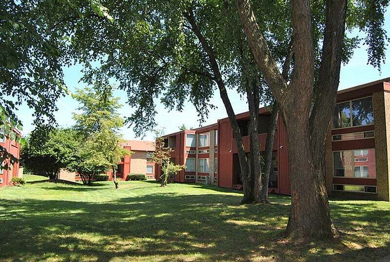 Spacious green courtyards and mature trees surround North Crossing Apartments in Willow Grove, PA. - North Crossing