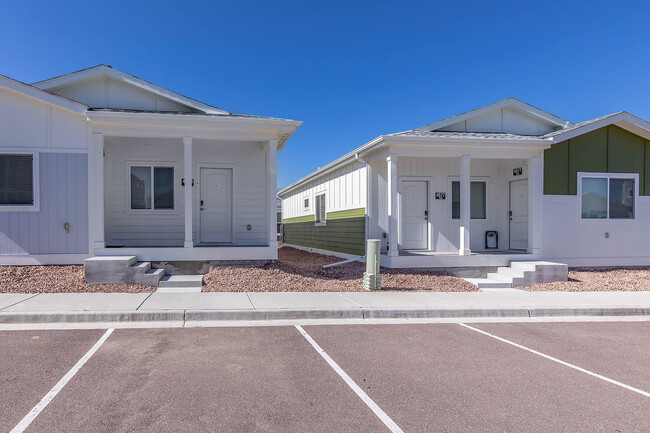 Explore the inviting exterior of this modern duplex, perfect for comfortable living. - Cottages at Mesa Ridge