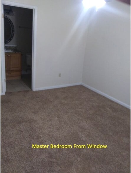 Master Bedroom looking from window/closet to the master bathroom. - 7933 Bles Ave