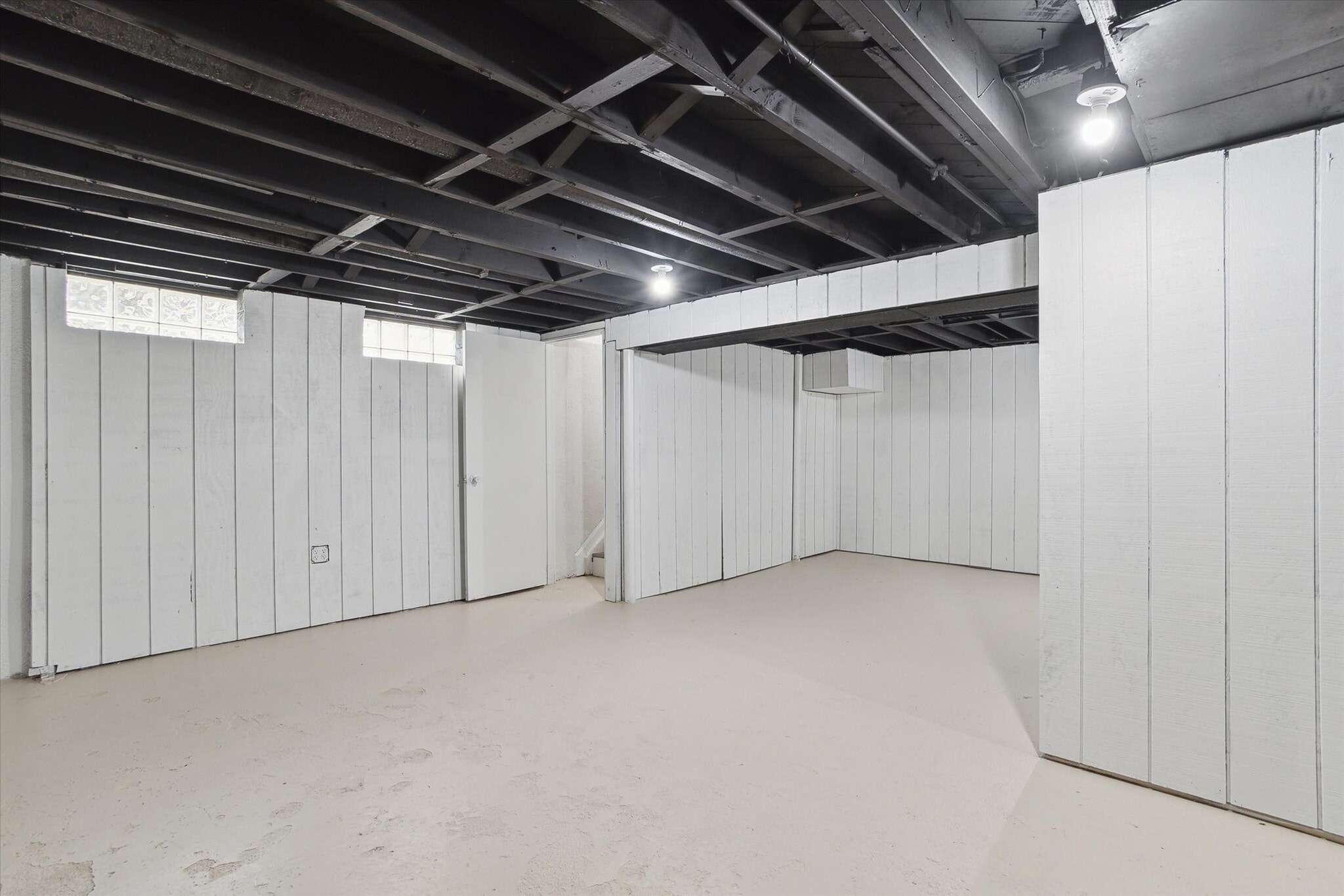 Basement entrance with extra bump out that could be used as an office space, home gym or play area. - 9244 Northern Ave