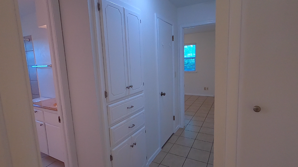 Hall with cabinets, drawers, and two closets - 415 W Guthrie St