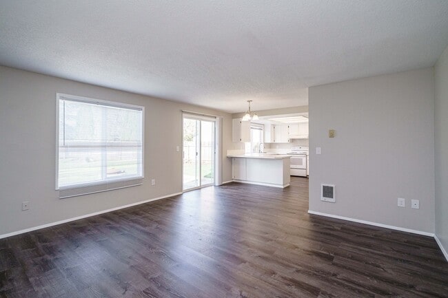 Building Photo - Recently Updated with Wood Laminate Flooring and Fresh Paint