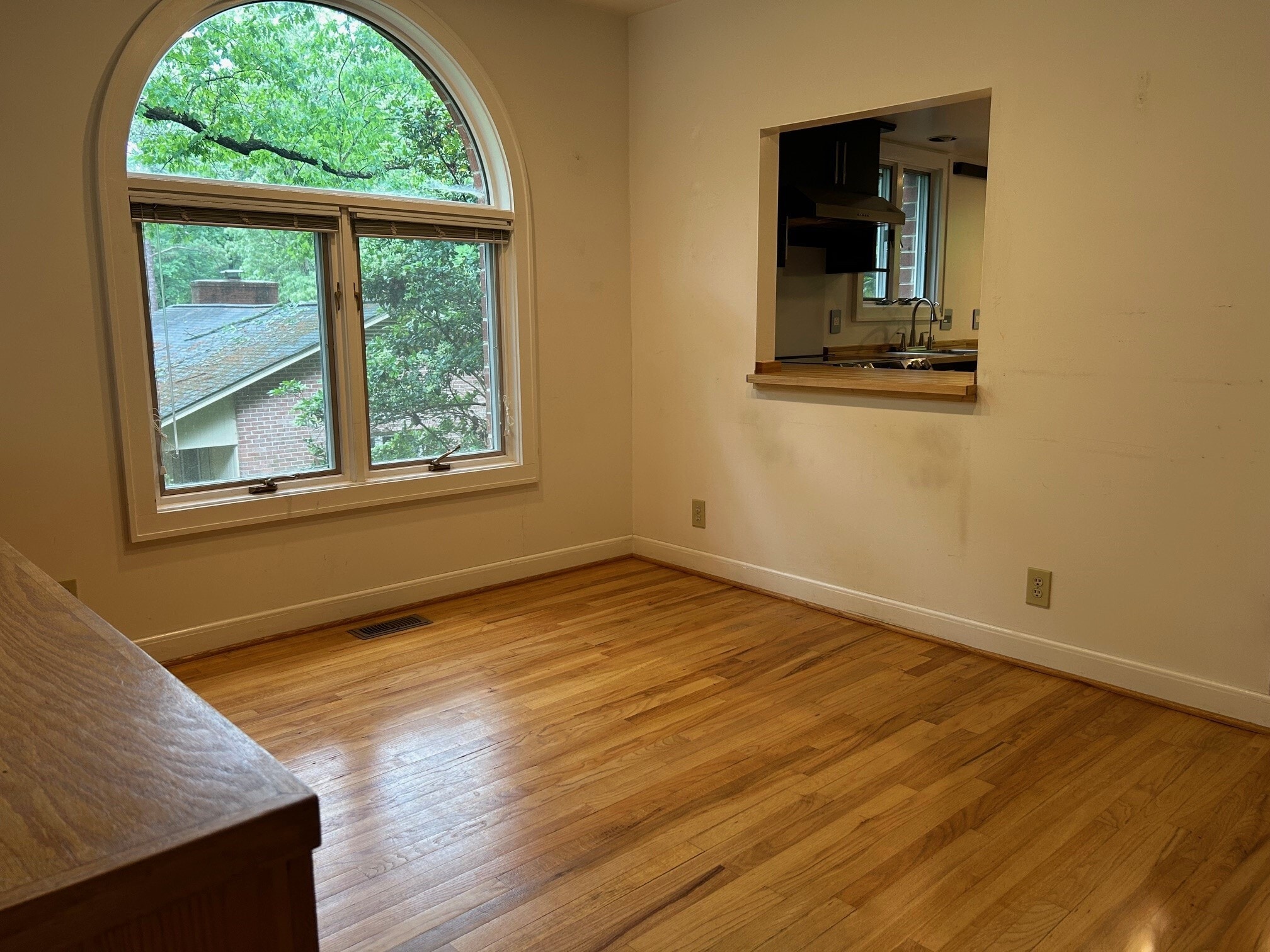 Dining room has large window and passthrough from kitchen - 407 McCauley St
