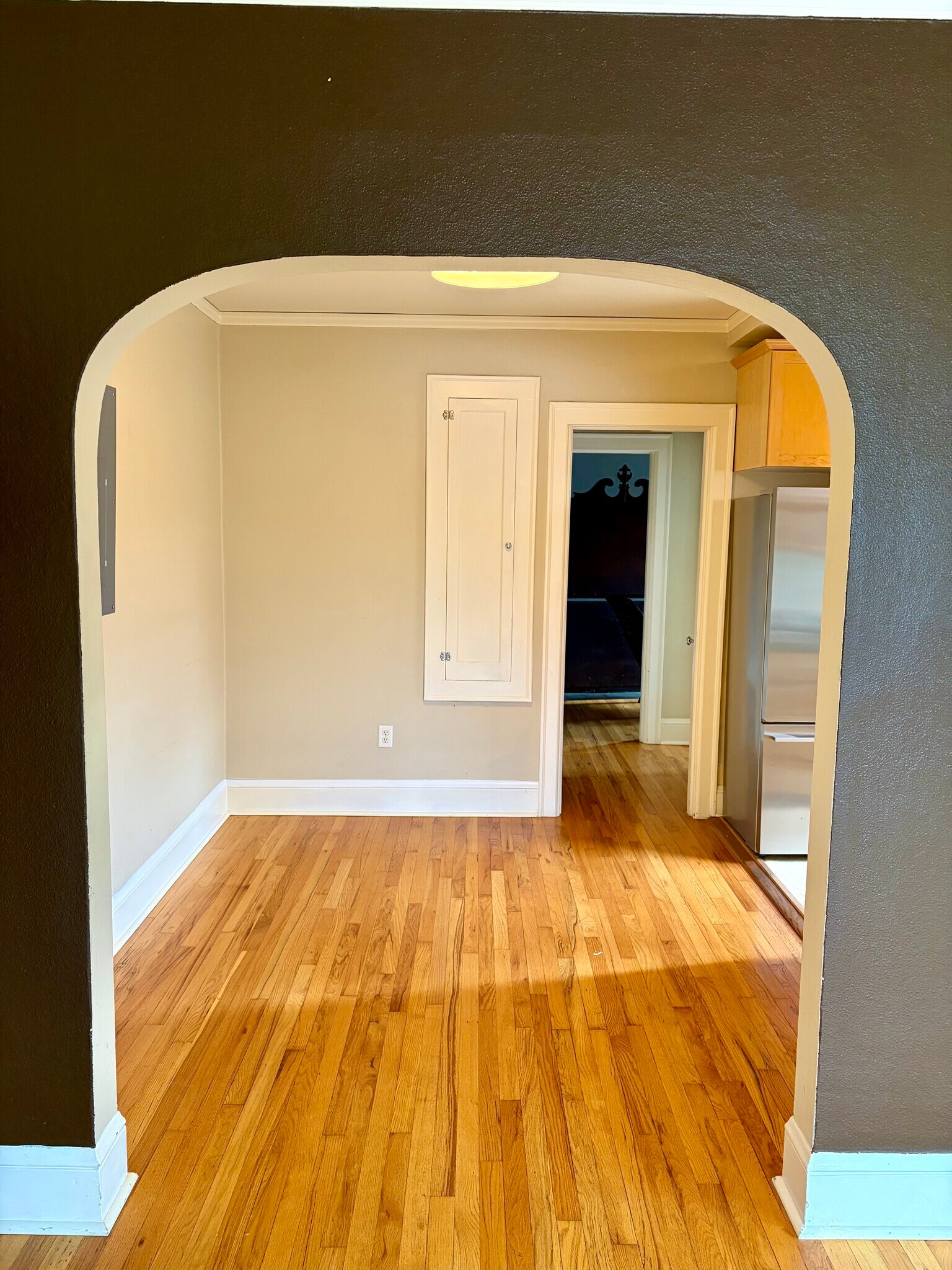 beautiful archway leading to spacious dining room complete with 1920s built in ironing board - 1509 NE 10th Ave