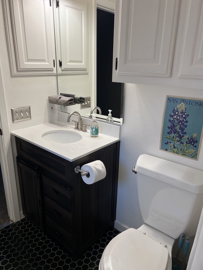 Primary bathroom with single vanity, primary window, and shower/bath combo - 5655 Larkdale Dr