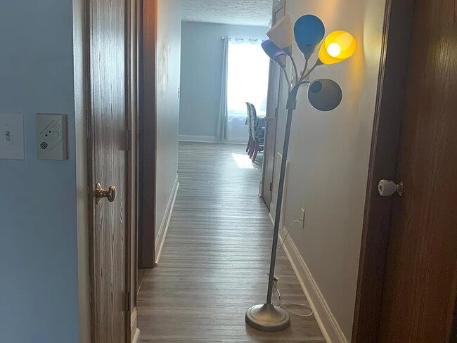 Building Photo - The home features beautiful LVP flooring, granite countertops, stainless steel appliances, and a ...