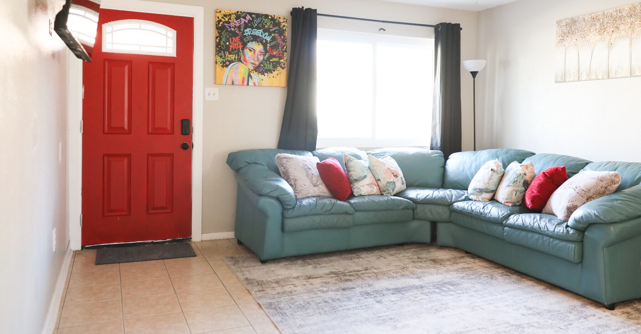Welcoming living room. Real leather corner sofa, red pops, comfort all around. - 8612 Echo St