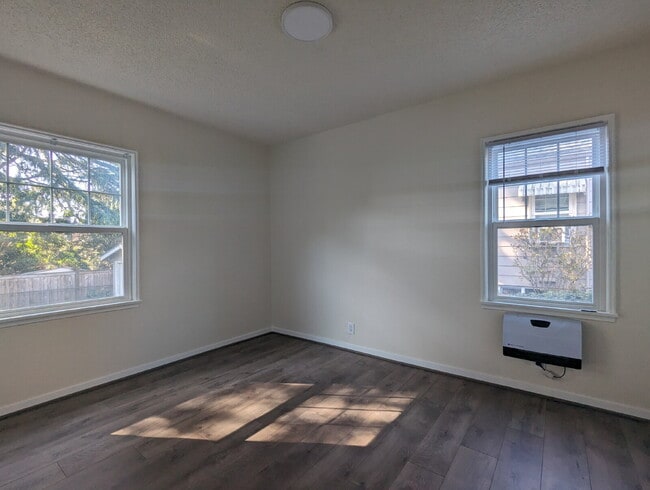 Building Photo - "Charming 3-Bedroom Duplex with Granite Touches & Gleaming Hardwood Floors in Seattle's Vibrant B...