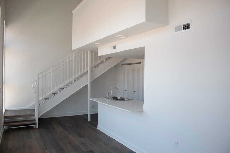 Open living area with kitchen island - 318 E 6th St