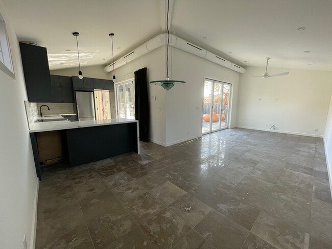 View from dining area to living area. Note two sets of accordion doors. - 5285 College View Ave