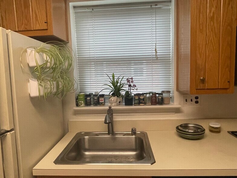 Window over kitchen sink adds light! Plenty of cabinets and counter space.See out the front and rear - 9707 Bristol Ave