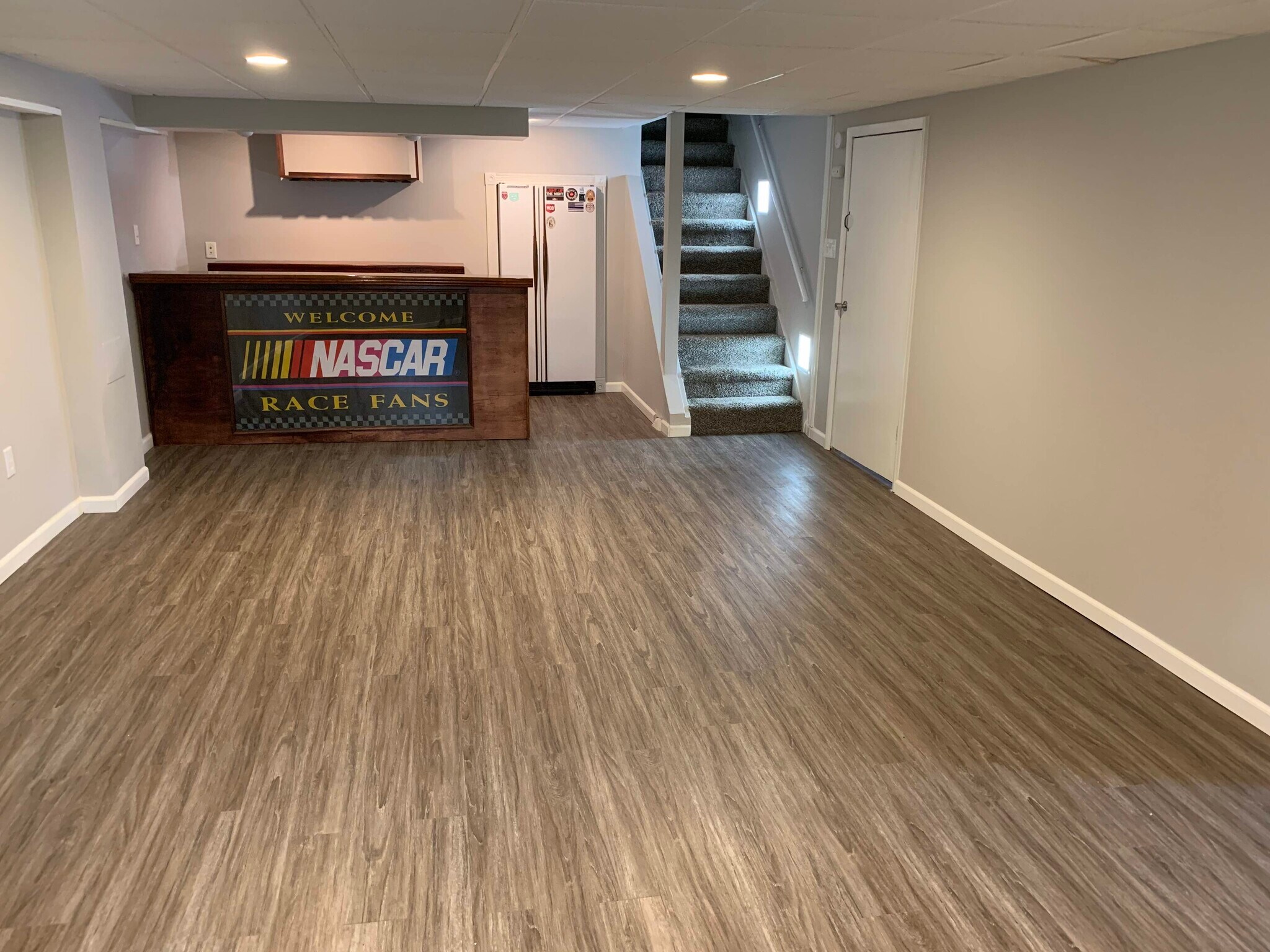 Finished basement, bar, fridge, new vinyl plank floors, carpet (steps), wall paint - 11934 Holly Brook Dr