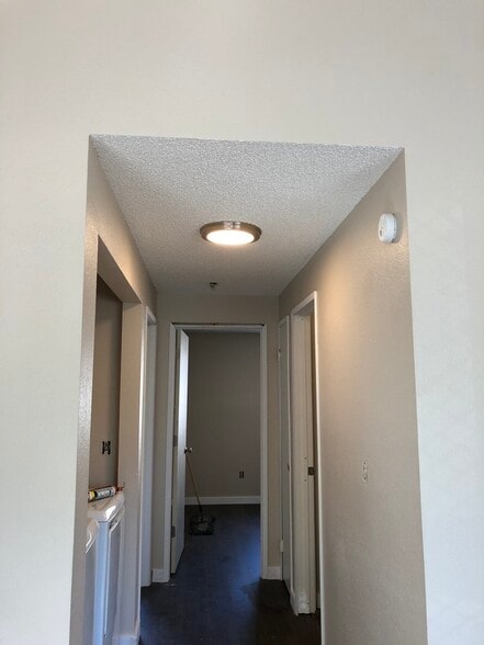 Hallway with washer and dryer as well as linens closet for storage - 219 E 36th St