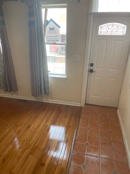 Living room, front door and windows - 604 Gerritt St