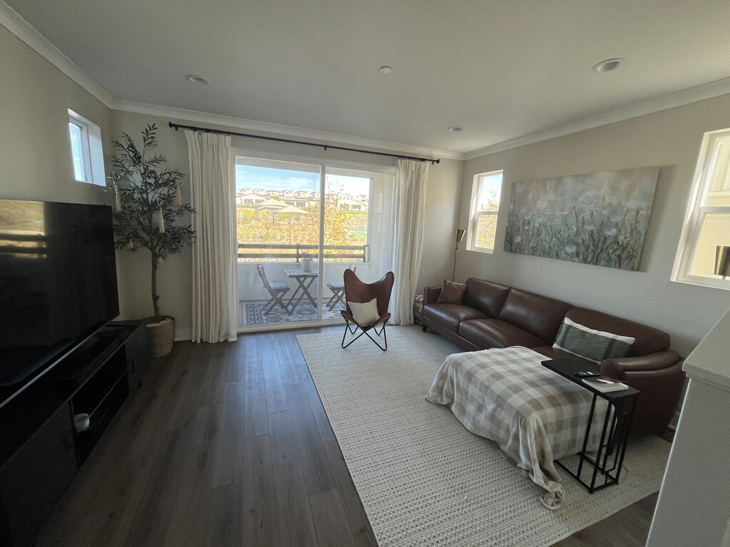 view of living area with view of park in front of home. Upgraded flooring and crown moulding. - 2241 Horseback Rd