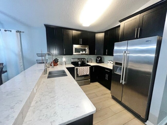 Building Photo - Lake Nona!! Spectacular 4X2 in Gated Nona Crest! All tile flooring!! 2 car garage! Move in April ...