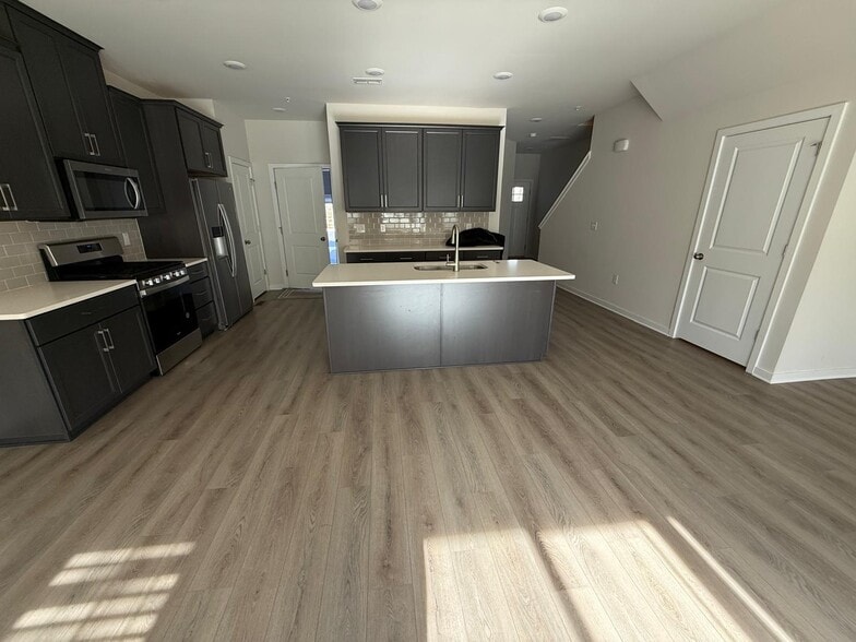 The kitchen is well-appointed with 42" cabinets in Pewter Maple color with crown molding, stylish wh - 3 Shamrock Cir